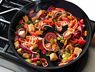 frying pan with meat and veggies